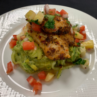 Blackened Grouper Filet served over Zoodles with Avocado Pesto, and Pineapple Citrus Salsa